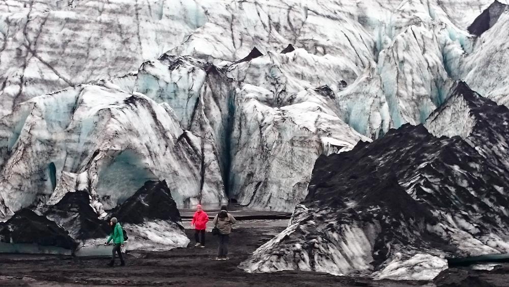 The glacier Solheimajokull with black sand volcanic ash