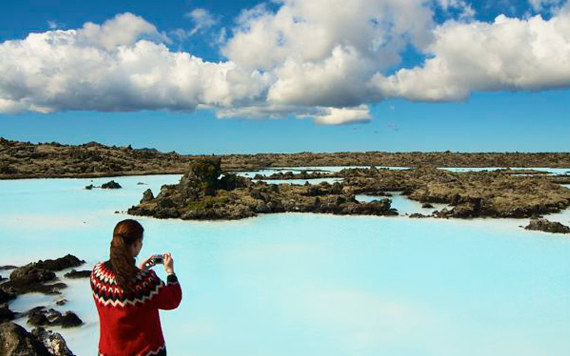 Blue seawater moss covered lava fields Blue lagoon spa blue sky