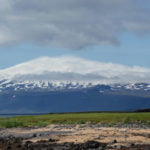 Snaefellsjokull glacier green grass blue sky ocean beach